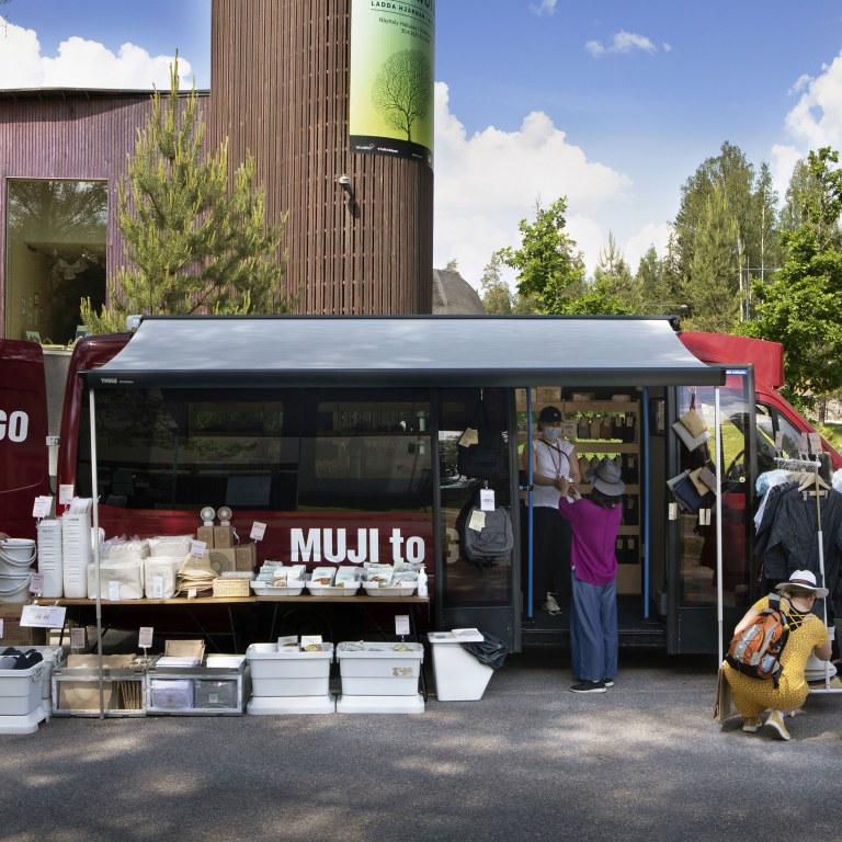 People shopping at a mobile store bus in the summer