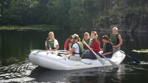 Seven persons raft on a beautiful lake