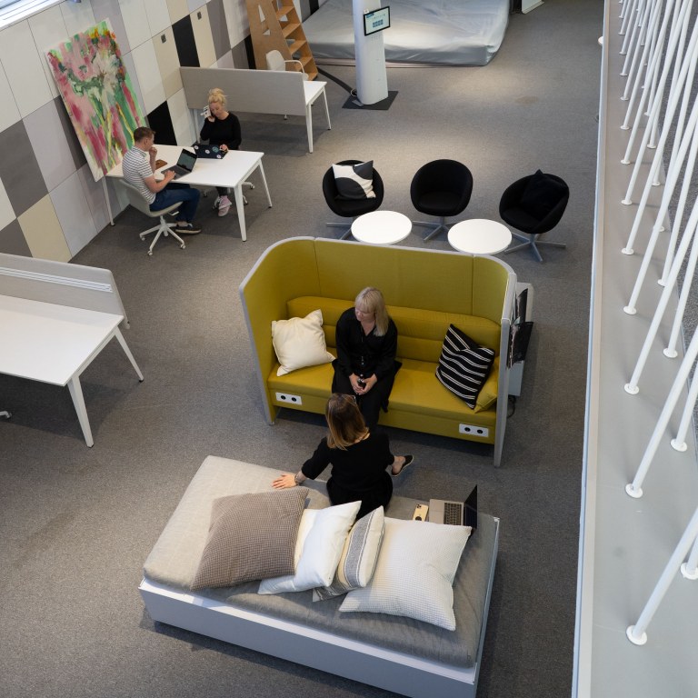 People sitting on sofas in a co-working space. 