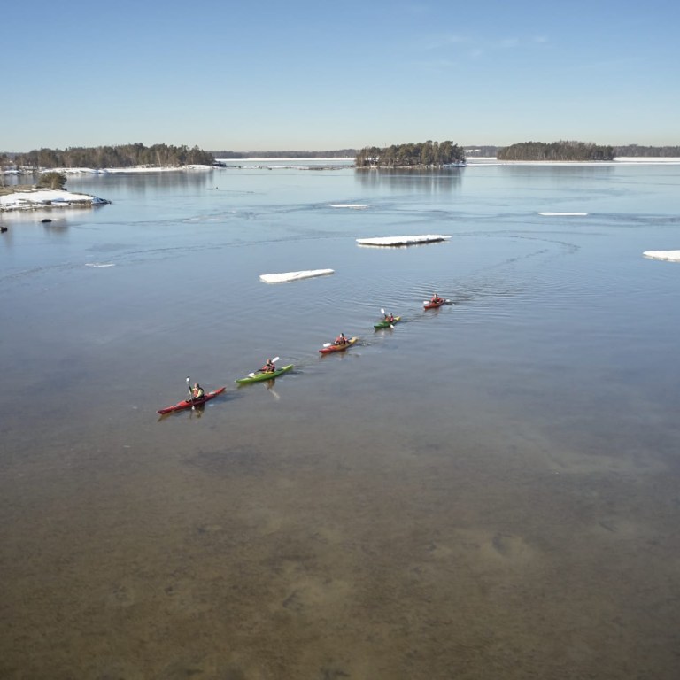 A group winter kayaking among icefloes