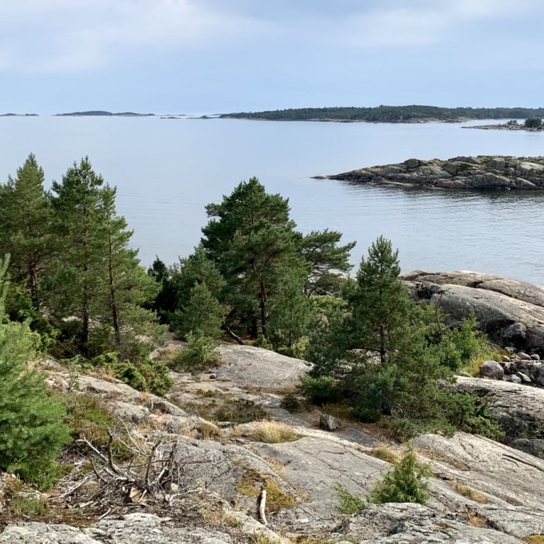 The scene from the Cape of Porkkala peninsula showcases small islands and a lighthouse. 