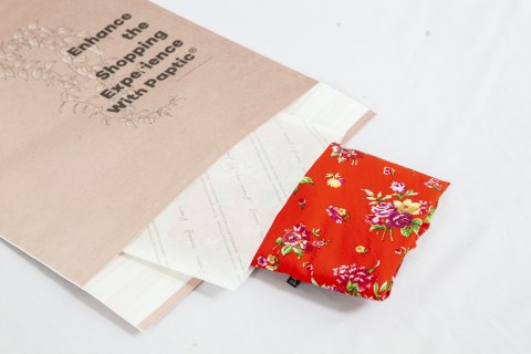 Brown, white and red envelopes of different sizes partly inside one another.
