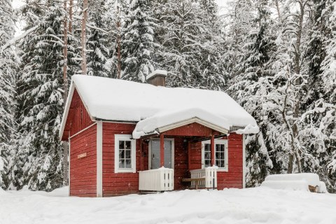 Wilderness cabin Tikankolo is covered by snow  in winter