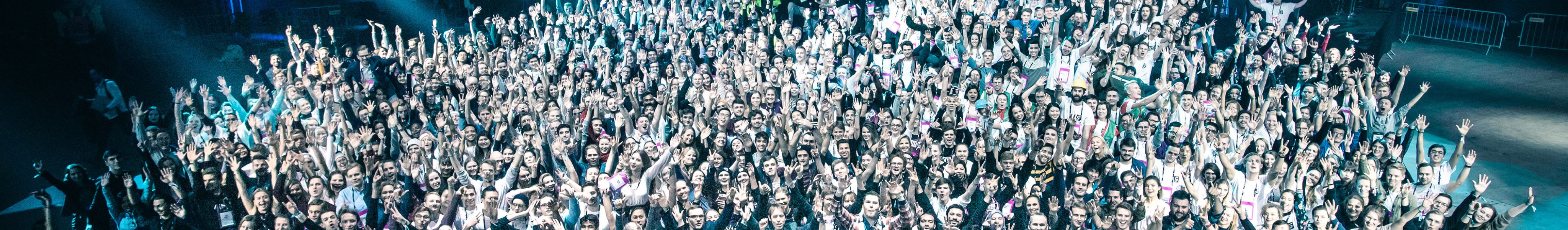 Image of a group that organised Slush startup event who are gathered together and celebrating towards the camera