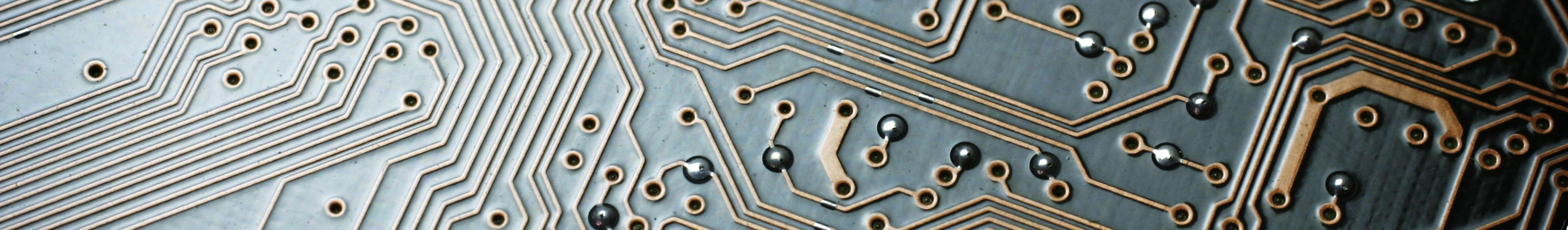 Closeup of a grey and brown computer circuit board.