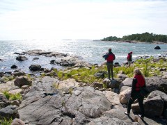 Three people walking at archipelago.