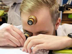 A watchmaking student doing precision work.